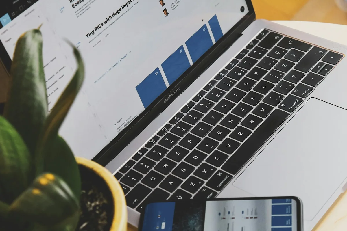 Website layouts being designed on a laptop and checked on a phone